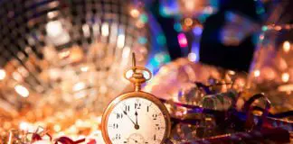 Small gold pocket watch surrounded by disco ball and tinsel at the las tiendas fun places in McAllen.